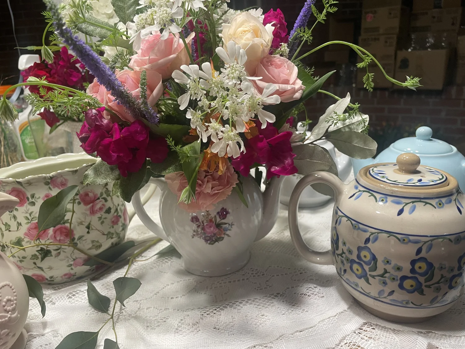 A vintage tea pot filled with homegrown flowers